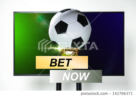 Sport bet on soccer with a trophy and a ball displayed on the screen Sport bet on soccer with a trophy and a ball displayed on the screen 142766371