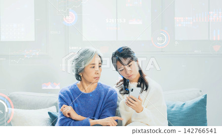 Parents and children looking at smartphones and statistical data 142766541
