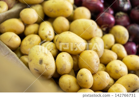 Farm potatoes in a basket at the market Farm potatoes in a basket at the market 142766731