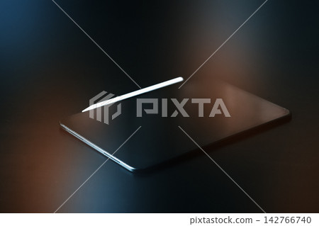 Laptop with a stylus on a dark surface in a workspace setting Laptop with a stylus on a dark surface in a workspace setting 142766740