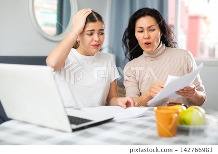 Worried LGBT couple working with papers Worried LGBT couple working with papers 142766981