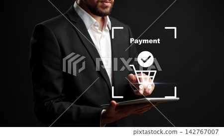 Online payment process using a tablet in a dark setting by a man in a suit Online payment process using a tablet in a dark setting by a man in a suit 142767007