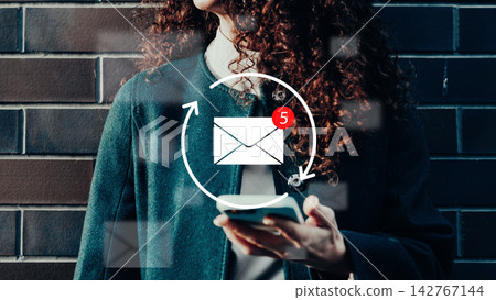 User looks at phone while notifications show on screen during a call in a city area User looks at phone while notifications show on screen during a call in a city area 142767144