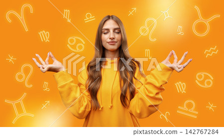 Zodiac signs surround a person practicing meditation with an orange background Zodiac signs surround a person practicing meditation with an orange background 142767284
