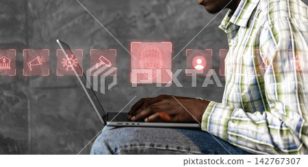 Deep fake technology shown on a laptop while a person works in an urban setting Deep fake technology shown on a laptop while a person works in an urban setting 142767307