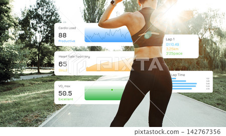Runner tracks performance data during a running session in a park in daylight Runner tracks performance data during a running session in a park in daylight 142767356