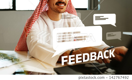 Man providing feedback in an office setting with chat bubbles displayed nearby Man providing feedback in an office setting with chat bubbles displayed nearby 142767492