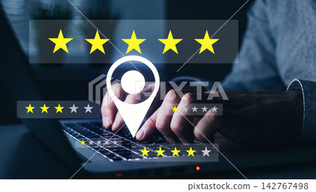 Feedback rating system on a laptop is being used by a person at home during night hours Feedback rating system on a laptop is being used by a person at home during night hours 142767498