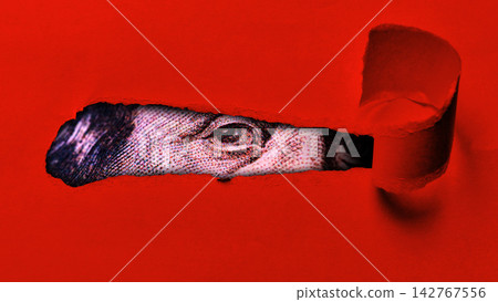 Close up view of dollar currency peeking through a torn red paper 142767556