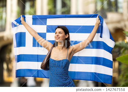 Young woman with Greek flag on city street Young woman with Greek flag on city street 142767558