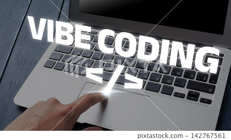 Vibe coding taking place on a laptop with a hand interacting with the trackpad 142767561
