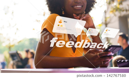 User interacts with mobile phone while receiving feedback at outdoor event during day User interacts with mobile phone while receiving feedback at outdoor event during day 142767580