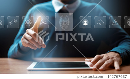 Person interacts with tablet displaying digital icons related to technology and deep fake applications Person interacts with tablet displaying digital icons related to technology and deep fake applications 142767687