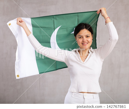 Young woman posing in studio with Pakistan flag Young woman posing in studio with Pakistan flag 142767861