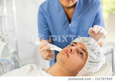 doctor deftly wields Skin Scrubbe doctor deftly wields Skin Scrubbe 142767949