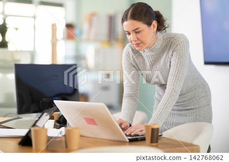 Working in modern office - businesswoman working on laptop Working in modern office - businesswoman working on laptop 142768062