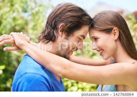 Couple, admiration and nature together for relationship, bonding love and caring look or outside date for romance. Blue sky, trees and summer holiday, happy and smile for quality time with partner Couple, admiration and nature together for relationship, bonding love and caring look or outside date for romance. Blue sky, trees and summer holiday, happy and smile for quality time with partner 142768064