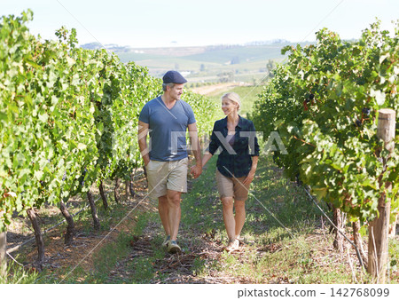 Happy, mature couple and holding hands at vineyard in Italy for bonding, hiking and conversation. Smile, senior man and woman walking at sustainable wine farm for travel adventure or holiday trip Happy, mature couple and holding hands at vineyard in Italy for bonding, hiking and conversation. Smile, senior man and woman walking at sustainable wine farm for travel adventure or holiday trip 142768099