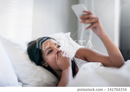 Girl, yawn and bed with phone in home for wake up, tired and check notifications and morning news. Woman, person and smartphone in bedroom for social media scroll, internet browsing and communication 142768356