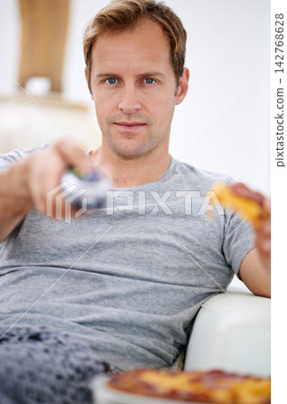 Happy, man and pizza for watching tv or movies on sofa for rest, relax and entertainment on weekend at home. Smile, male person and fast food with remote for streaming film and television for comfort Happy, man and pizza for watching tv or movies on sofa for rest, relax and entertainment on weekend at home. Smile, male person and fast food with remote for streaming film and television for comfort 142768628