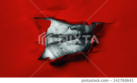 Money currency dollar seen through a torn red piece of paper representing value and economics Money currency dollar seen through a torn red piece of paper representing value and economics 142768641
