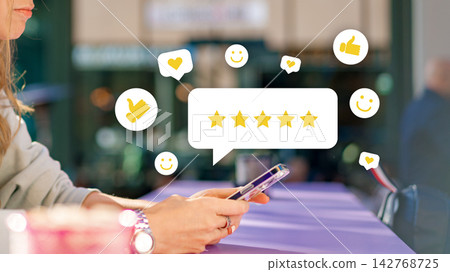 Person giving a rating on a mobile device while sitting at a table outside on a sunny day Person giving a rating on a mobile device while sitting at a table outside on a sunny day 142768725