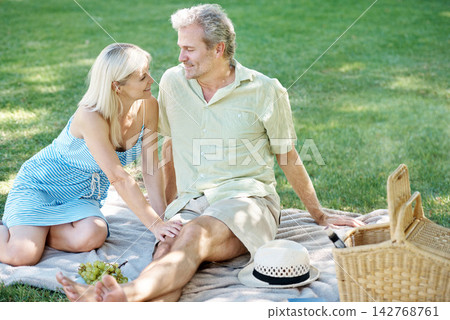 Happy, smile and couple on picnic in park for anniversary, adventure and holiday together. Man, woman and love on blanket at countryside for marriage, bonding and outdoor romance in New Zealand Happy, smile and couple on picnic in park for anniversary, adventure and holiday together. Man, woman and love on blanket at countryside for marriage, bonding and outdoor romance in New Zealand 142768761