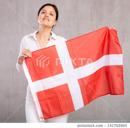 Young woman posing in studio with Denmark flag Young woman posing in studio with Denmark flag 142768804