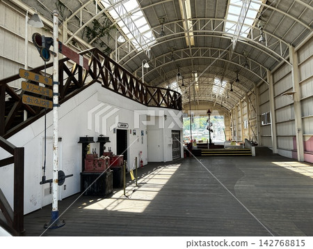 A retro train station and platform in a theme park, bathed in sunlight and exuding a nostalgic atmosphere. A retro train station and platform in a theme park, bathed in sunlight and exuding a nostalgic atmosphere. 142768815