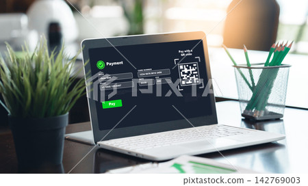 Online payment process on a laptop with QR code displayed on the screen in a modern office setting Online payment process on a laptop with QR code displayed on the screen in a modern office setting 142769003