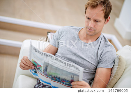Man, newspaper and relax on couch for peace, calm and comfortable on weekend in living room. Male person, reading and article in apartment, information and rest on sofa in pyjamas for story update Man, newspaper and relax on couch for peace, calm and comfortable on weekend in living room. Male person, reading and article in apartment, information and rest on sofa in pyjamas for story update 142769005