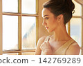 Woman, beauty and luxury in house with fancy, elegant and classy in fashion by window for wealth aesthetic. Female person, style and vintage mansion for gala, thinking or event with confidence 142769289