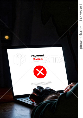 Payment process shows a failed status on a laptop screen in a dimly lit room Payment process shows a failed status on a laptop screen in a dimly lit room 142769361