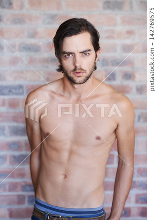 Shirtless, man and portrait in home with tattoo, skincare or confidence on brick wall in apartment. Male, model and body art with topless person in house with pride and calm energy in morning Shirtless, man and portrait in home with tattoo, skincare or confidence on brick wall in apartment. Male, model and body art with topless person in house with pride and calm energy in morning 142769575