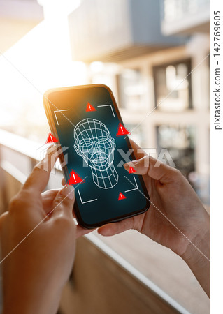 Detecting deep fake technology on a smartphone in a modern city setting during sunset 142769605