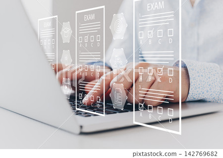 E learning and digital exam process taking place on a laptop in a home office setting E learning and digital exam process taking place on a laptop in a home office setting 142769682