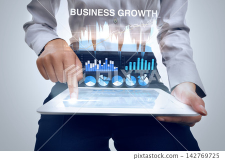 Hologram, tablet and data analytics with hands, future with graphs and stats for business growth on grey background. Information, 3D and dashboard, person with corporate revenue report and research Hologram, tablet and data analytics with hands, future with graphs and stats for business growth on grey background. Information, 3D and dashboard, person with corporate revenue report and research 142769725