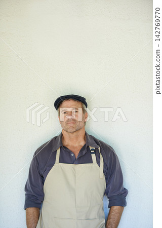 Portrait, man and cafe owner on wall background with confident startup business manager on mockup space. Face, entrepreneur and mature professional in apron at restaurant for seller career in Germany Portrait, man and cafe owner on wall background with confident startup business manager on mockup space. Face, entrepreneur and mature professional in apron at restaurant for seller career in Germany 142769770