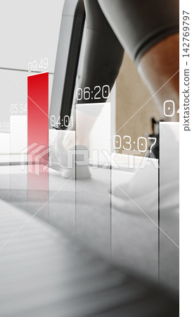 Running on treadmill while monitoring time and performance metrics in gym Running on treadmill while monitoring time and performance metrics in gym 142769797