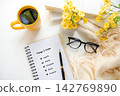 Notebook with things I value inspiring new beginnings and future life planning with yellow cup coffee in worm sunshine.  Goal Life Wellness Concept. 142769890