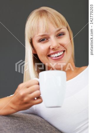 Portrait, coffee and woman on sofa with mug for happiness, relax or morning routine in living room. Smile, drink and person with hot beverage for enjoyment, stress relief or weekend break in home Portrait, coffee and woman on sofa with mug for happiness, relax or morning routine in living room. Smile, drink and person with hot beverage for enjoyment, stress relief or weekend break in home 142770203