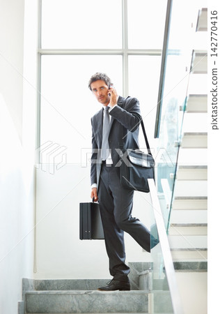 Business man, phone call and speaking on stairs in office, networking and consultant for planning. Male person, communication and steps for deal negotiation, briefcase and leave work for connection Business man, phone call and speaking on stairs in office, networking and consultant for planning. Male person, communication and steps for deal negotiation, briefcase and leave work for connection 142770416