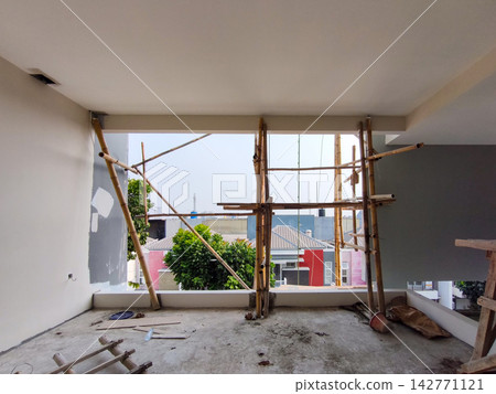 Bamboo scaffolding installed at residential house window Bamboo scaffolding installed at residential house window 142771121