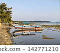 Traditional fishing boat on shallow shore low tide 142771210