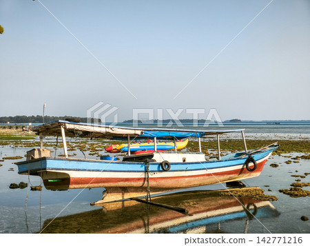 Traditional Wooden Boat Anchored 142771216