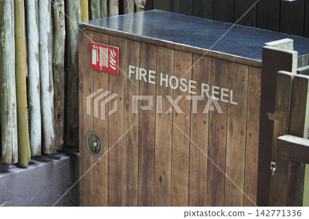 Fire hose reel located in a wooden enclosure at a public place Fire hose reel located in a wooden enclosure at a public place 142771336