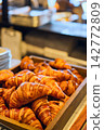 A huge pile of croissants 142772809