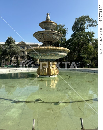 Antique fountain in the city park in summer. Antique fountain in the city park in summer. 142773301
