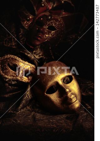 Golden carnival masks on a dark background. Golden carnival masks on a dark background. 142773487
