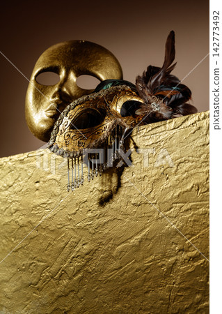 Golden carnival masks on a gold background. Golden carnival masks on a gold background. 142773492